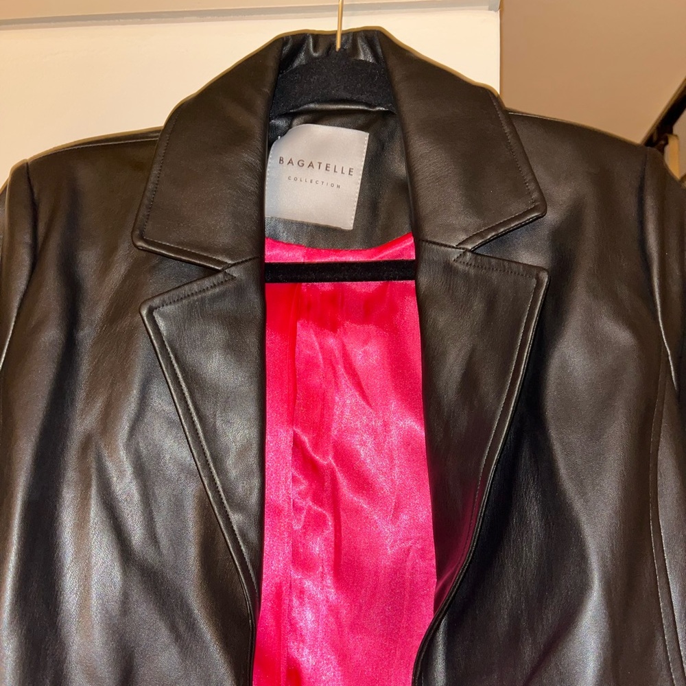 Bagatelle vegan leather mid-length coat in black with hot pink silky lining